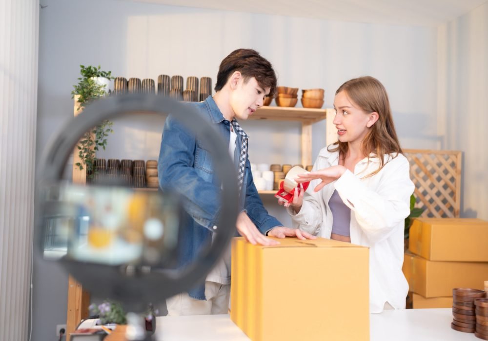 A young couple runs a small business making clay jewelry. They support one another as they work toward becoming larger business in the future.