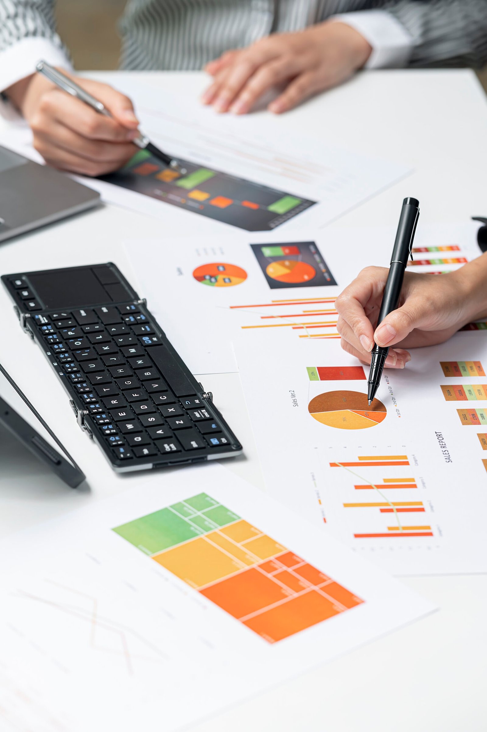 business people hands working on graph and chart of business dat Cropped shot of business people hands working on graph and chart of business data information at office desk. Vertical view.