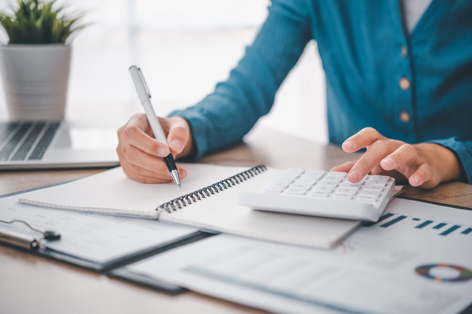 close up The business person is sitting on a calculator with a g close up The business person is sitting on a calculator with a graph in the office of finance accounting concept
